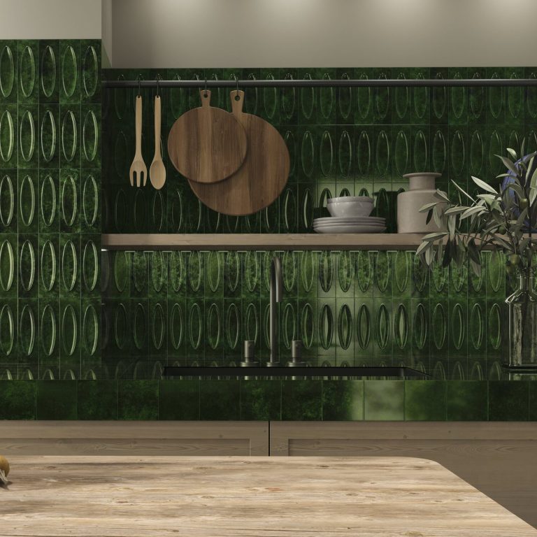 A kitchen backsplash with glossy, dark green rectangular tiles, neatly arranged in a horizontal stack bond pattern. The tiles have a rich, reflective finish that adds depth and a modern touch to the kitchen. The countertop below holds white dishes and glassware, creating a stylish contrast against the green tiles.